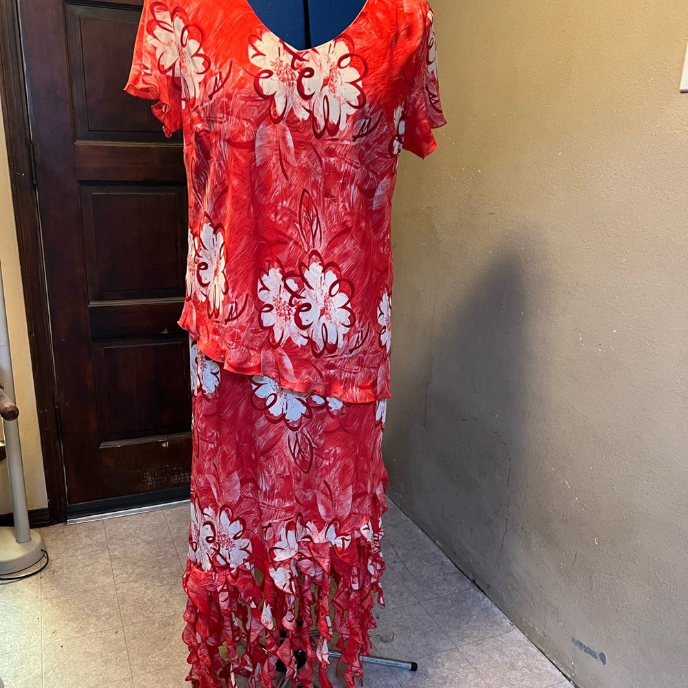 This orange/red with flowers and has beautiful hemline that is curly fringed!